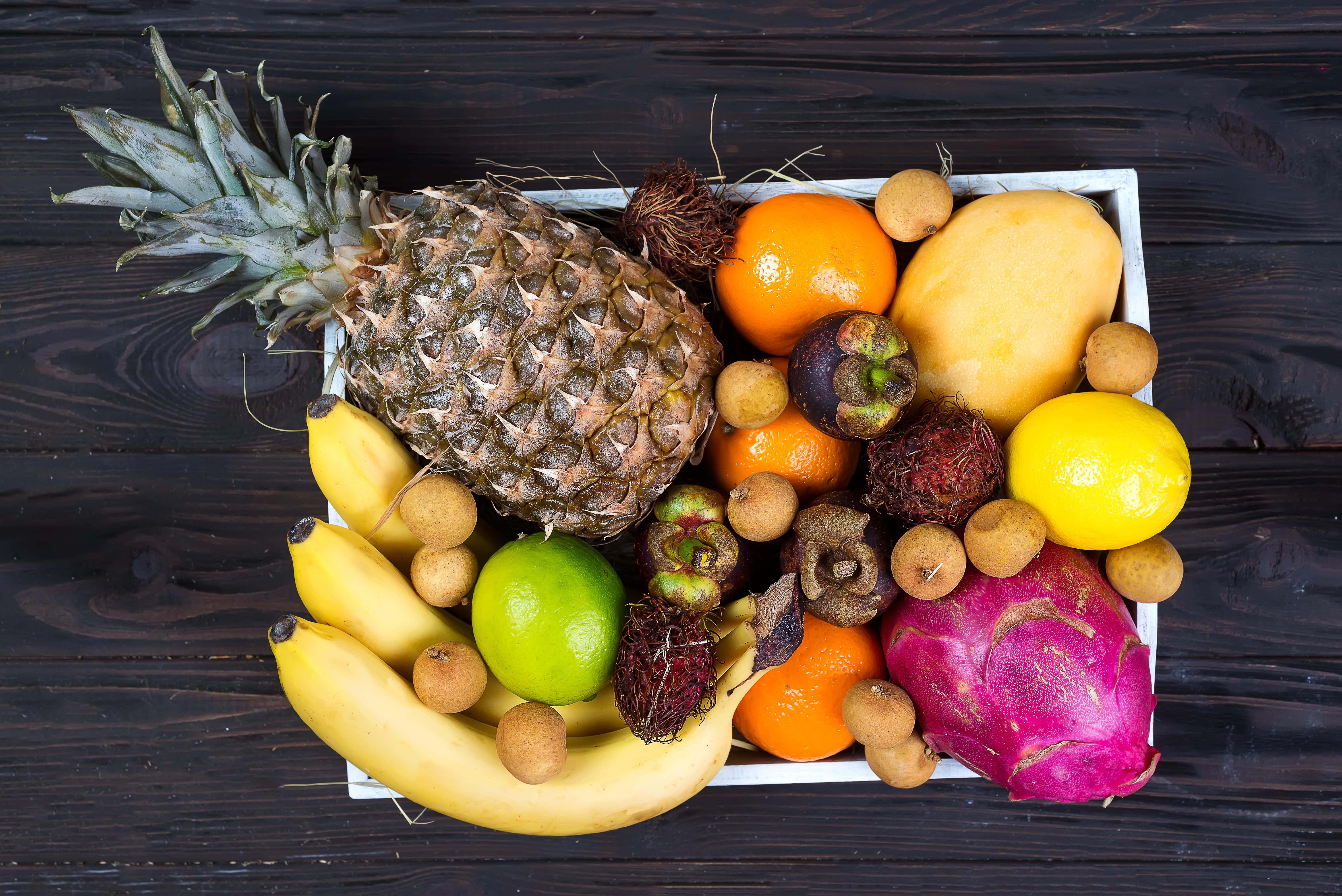 fresh-exotic-fruits-in-a-wooden-box-top-view-with--L3576Z2-min